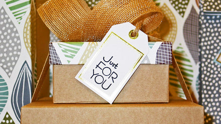 stacked boxes with paper tag reading "just for you"