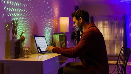 man in home office with star projector lighting