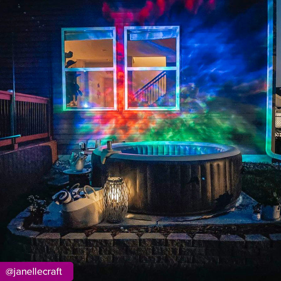 backyard hot tub with lantern and multicolor galaxy lights