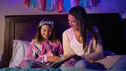 mom and daughter reading stories in bed