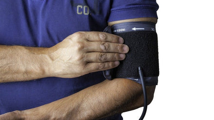 man wearing blood pressure monitor