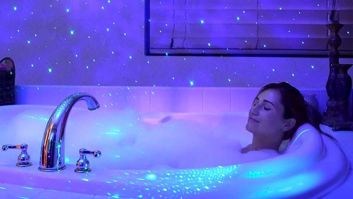 woman in bathtub with galaxy lights