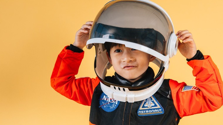 boy wearing astronaut helmet