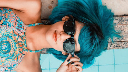 woman with blue hair and sunglasses