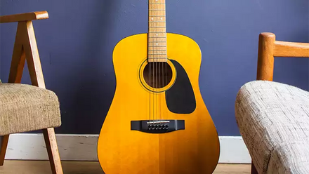 acoustic guitar between two chairs