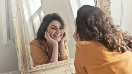 woman smiling in mirror