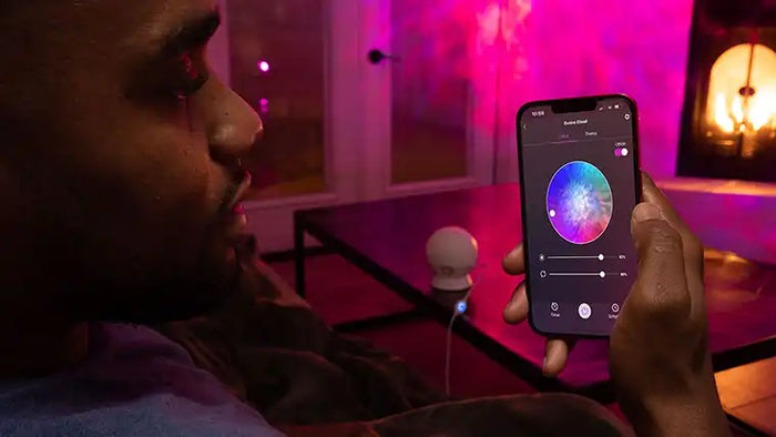 man controlling smart lights from app