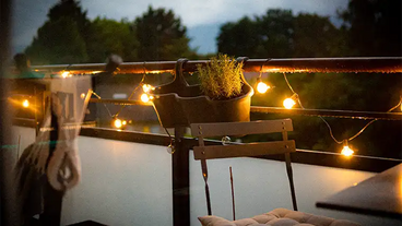balcony with string lights and planters
