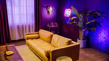 man cave with yellow couch and colorful lights