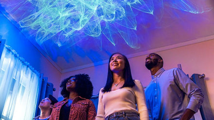 people smiling at aurora lights on ceiling