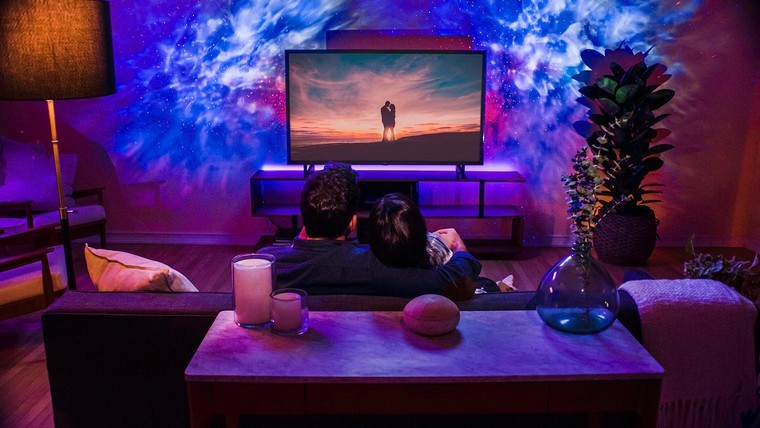 couple watching a movie with galaxy lights