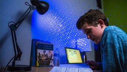 student studying with laser lights