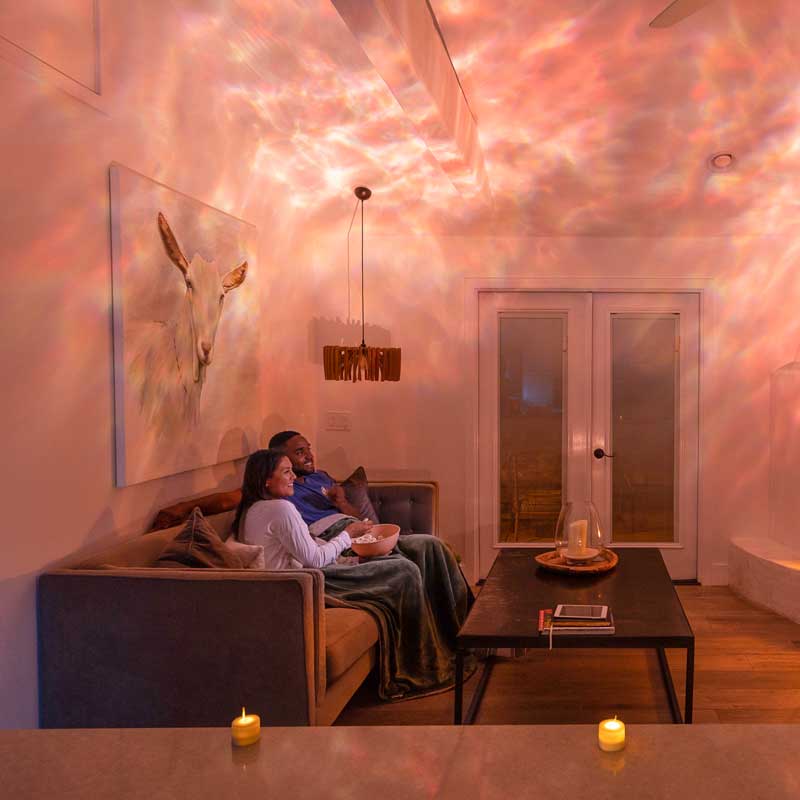 couple in living room with orange galaxy lights