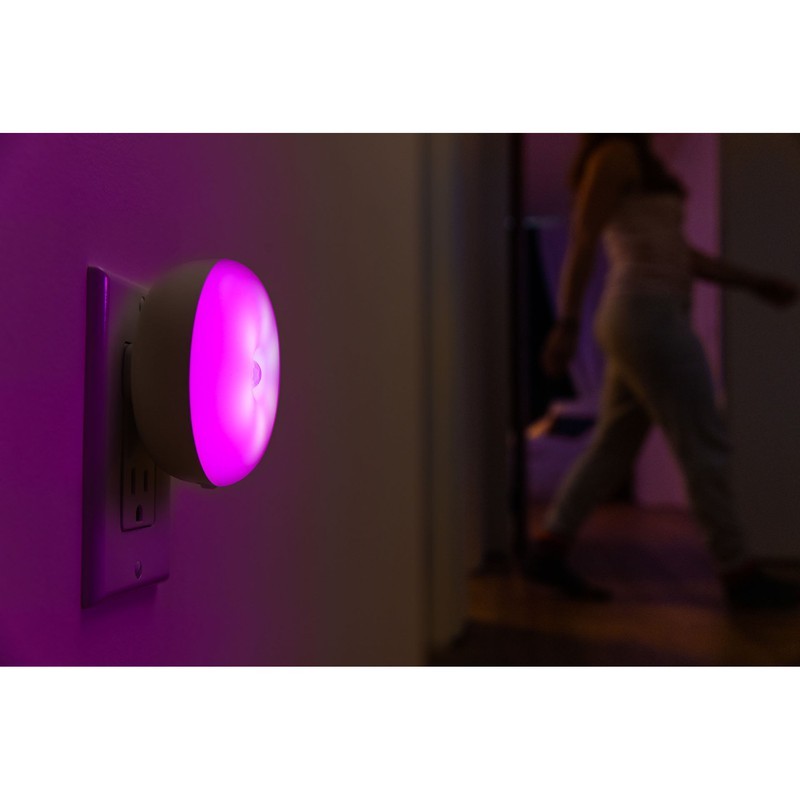 woman walking past blissember smart color changing night light in pink