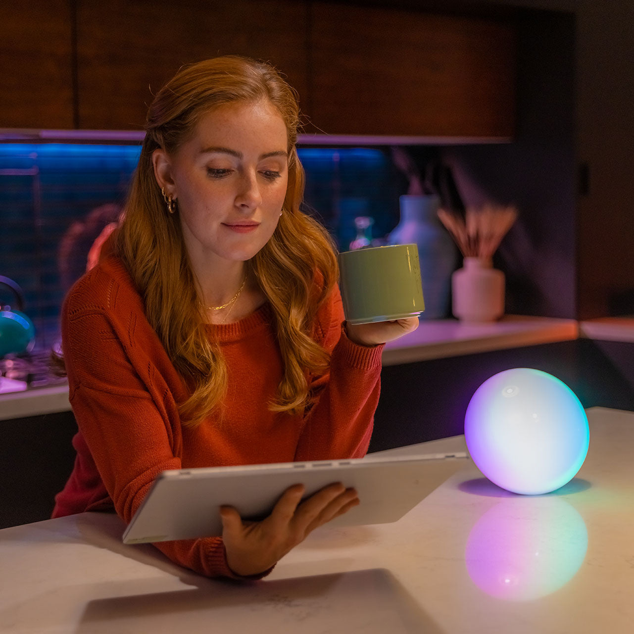 woman reading laptop next to blissradia smart mood lights