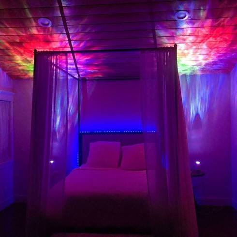 bedroom with multicolor galaxy lights on nightstands